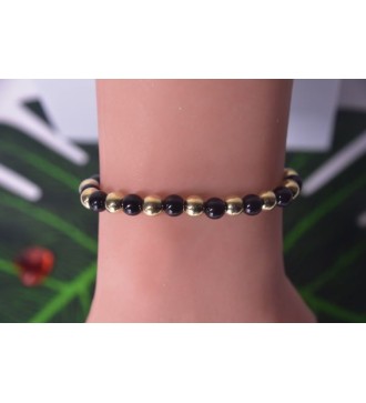 Bracelet en perles noires et dorées , chic et élégant